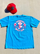 Load image into Gallery viewer, Bright Blue Tee, with large front screened No Kooks, No Commies Beach Club Jolly Roger design.
